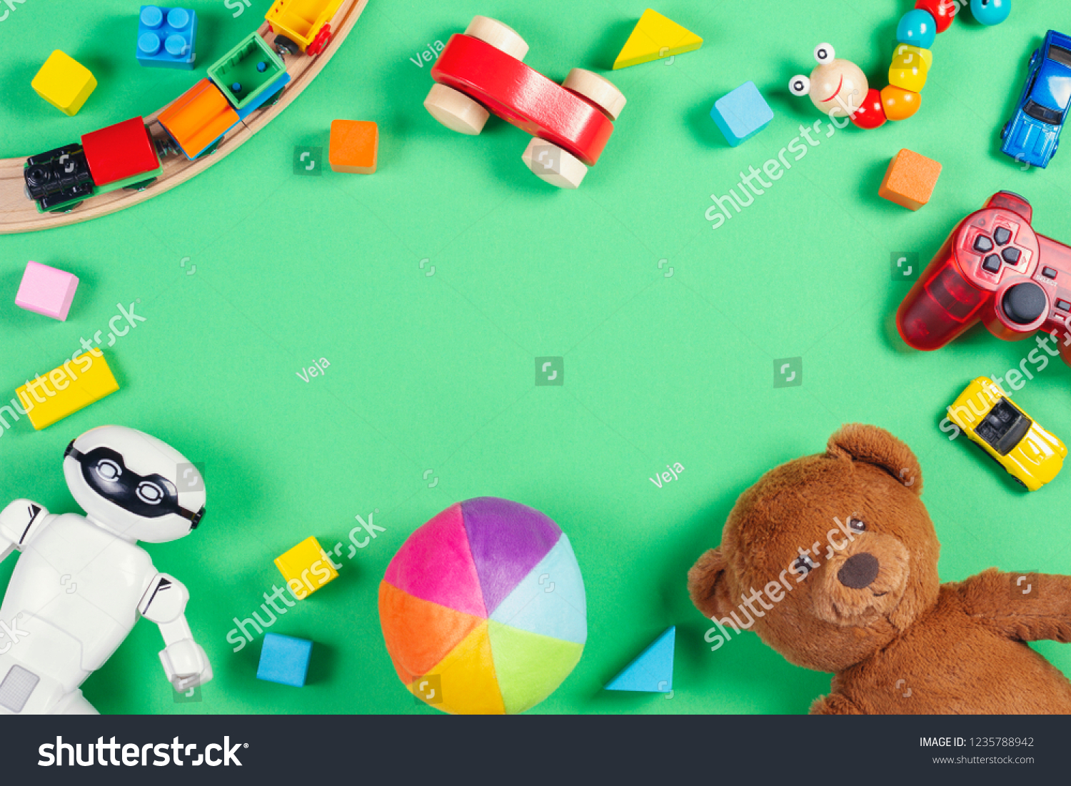 Baby kids toys frame with teddy bear toy cars robot colorful bricks cubes on pink background