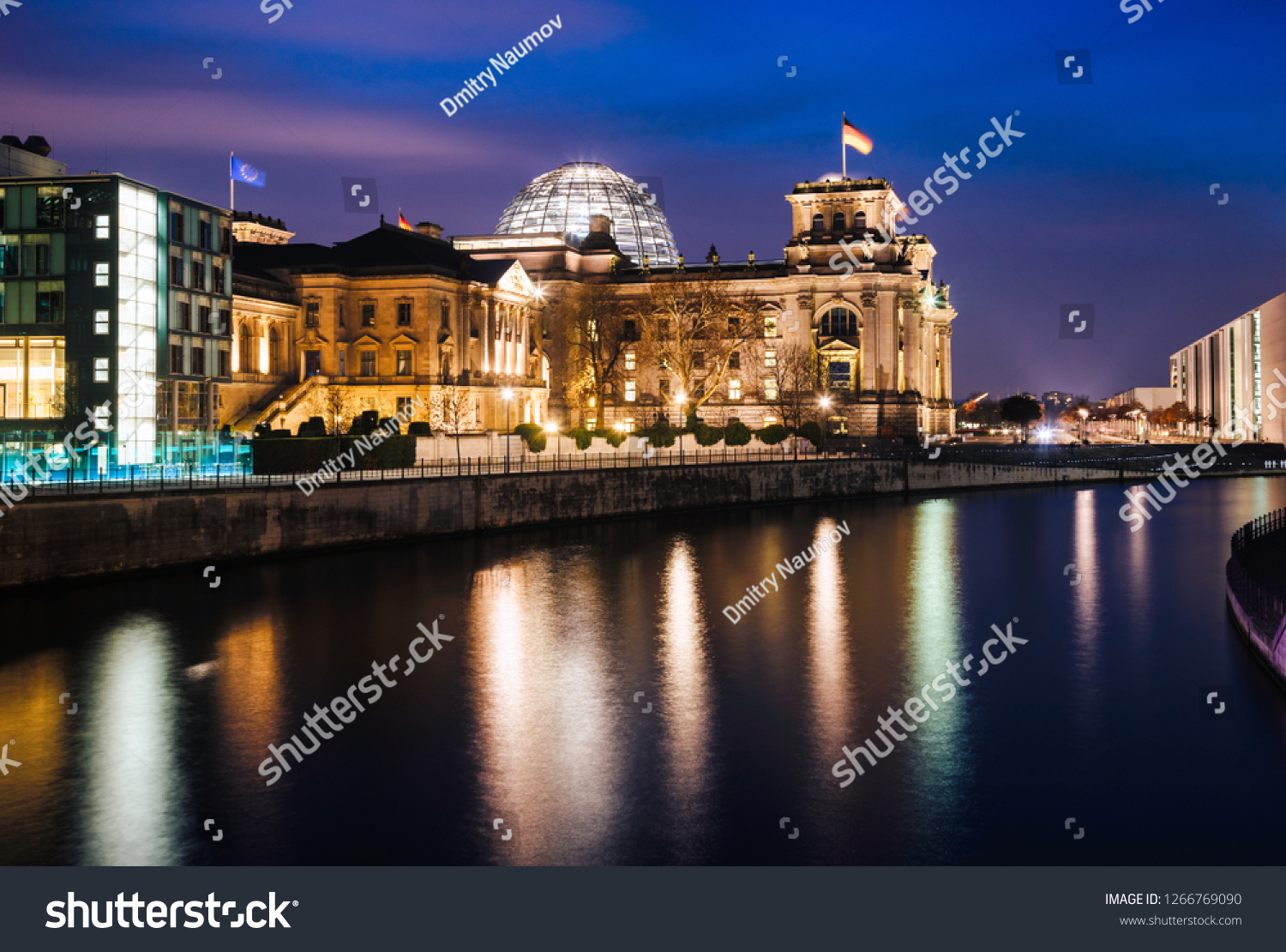 Illuminated Neo-Renaissance Reichstag Building one of the best known landmarks of Germany and seat of the German Parliament as viewed from across the Spree river at night Central Berlin Germany