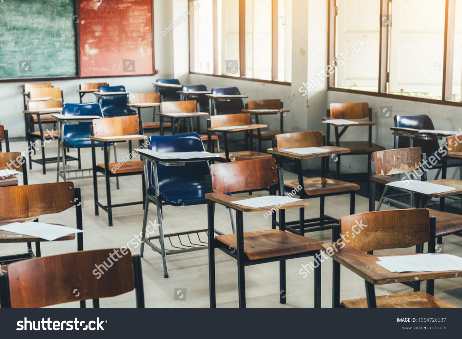 selective soft and blur focus.old wooden row lecture chairs in classroom in poor school.study room without student.concept for education