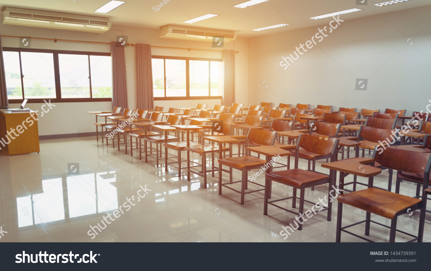 Empty university classroom with wooden chairs and desks. Modern university lecture room without student.