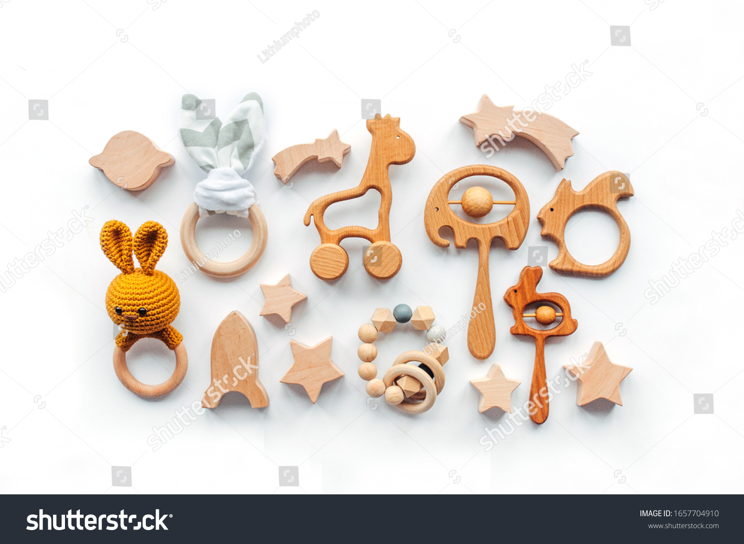 Eco friendly non plastic toys concept. Baby background. Wooden toys and teethers on white background with blank space for text.