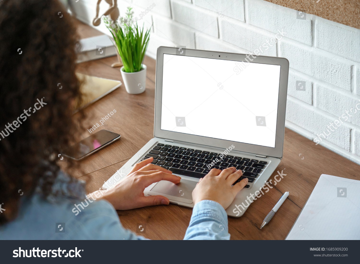 African girl school student e learning distance training course study work at home office. Ethnic young woman watching online education webinar using laptop. Over shoulder close up mock up screen view