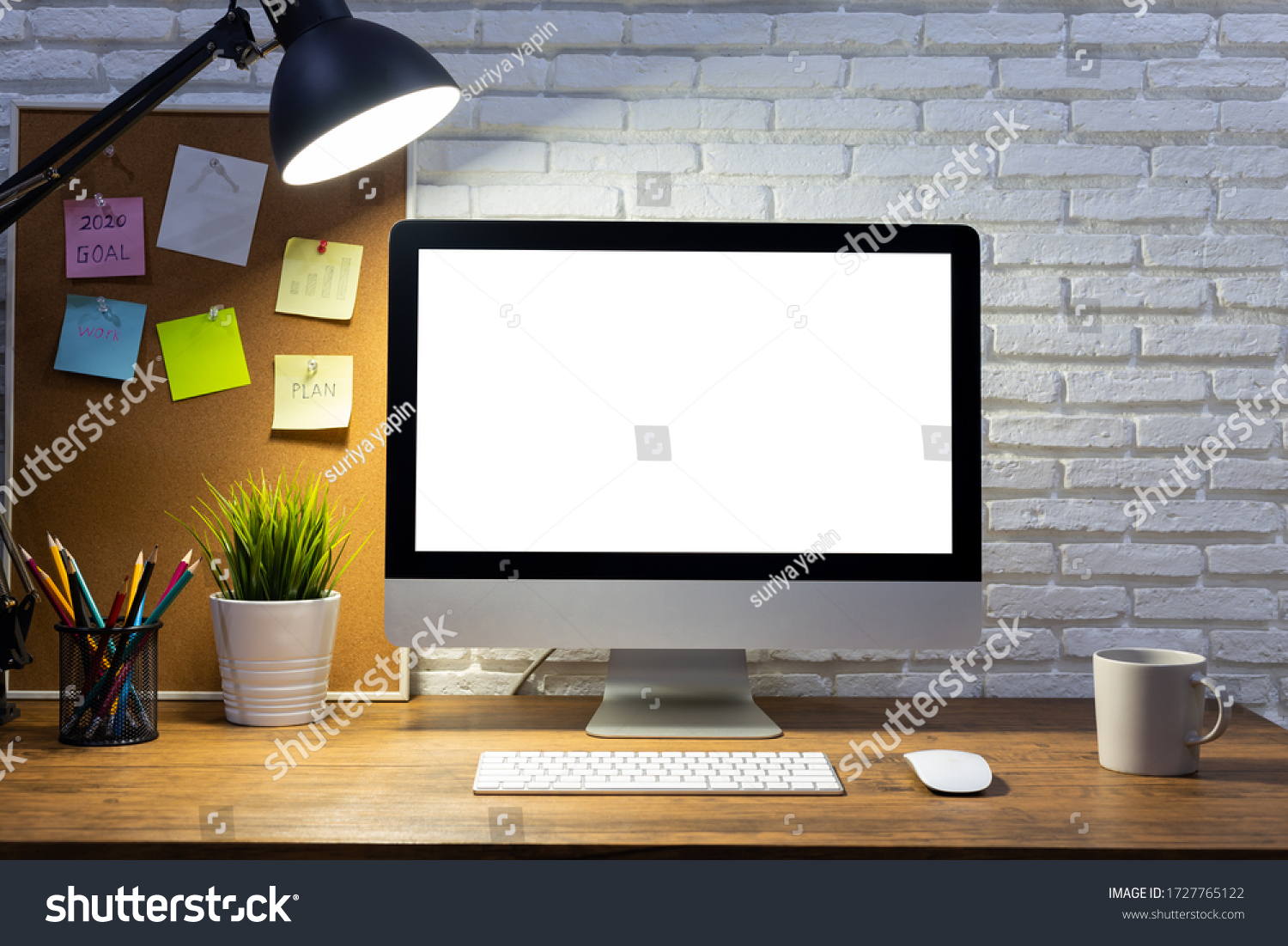 workspace with computer with blank white screen mockup and office supplies on a wooden desk