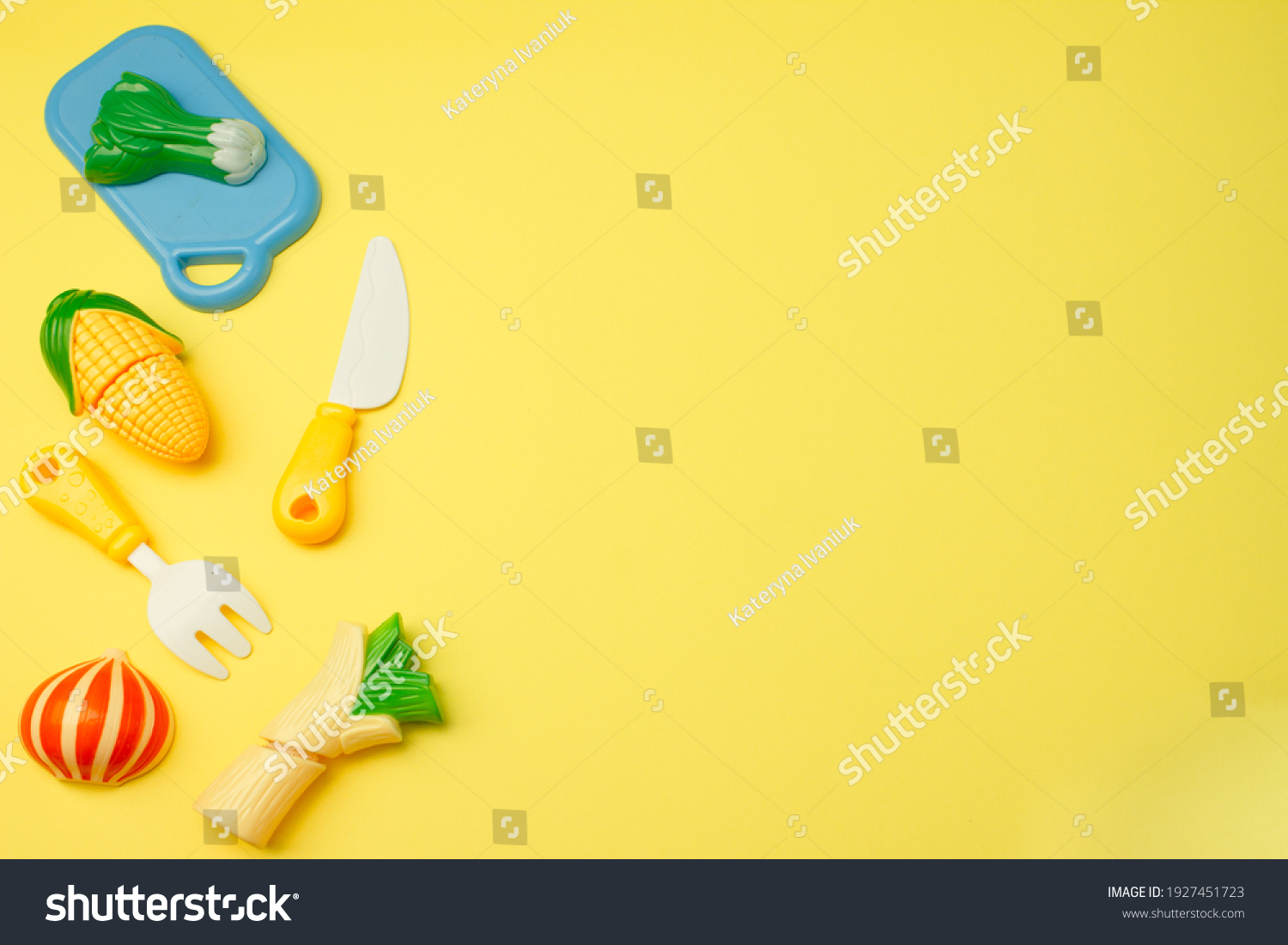 Creative composition of toy fruits and vegetables on a pastel yellow background. Minimum summer concept. Surrealism.