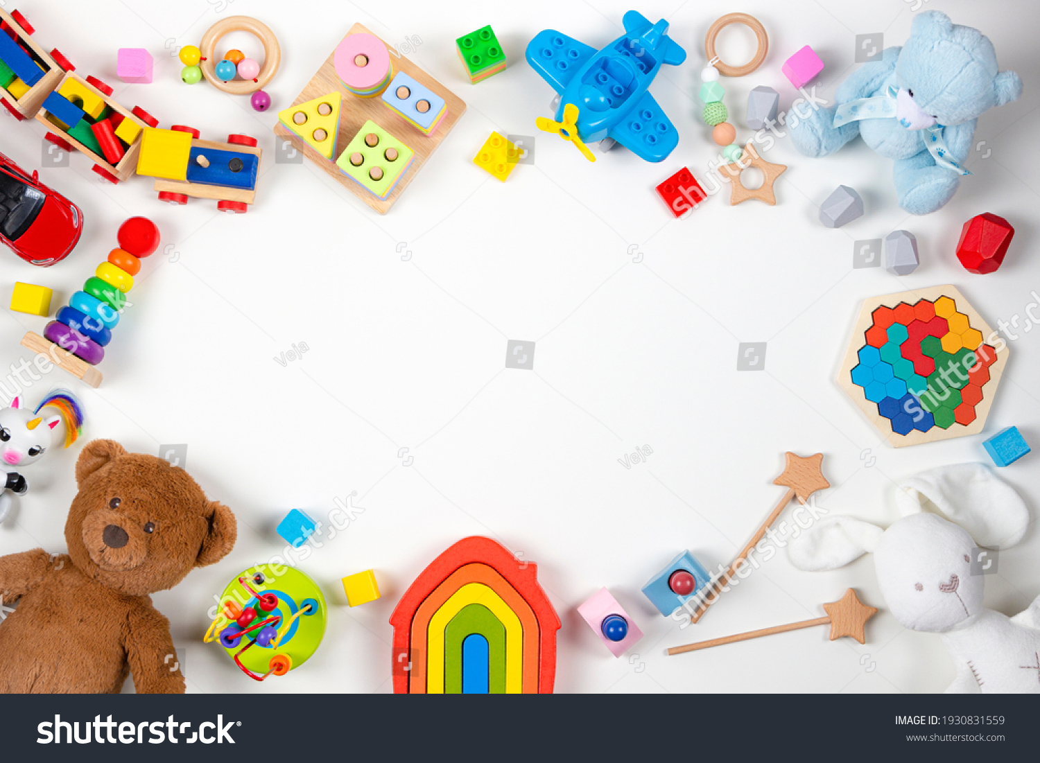 Baby kids toys frame. Set of colorful educational wooden and fluffy toys on white background. Top view flat lay copy space for text
