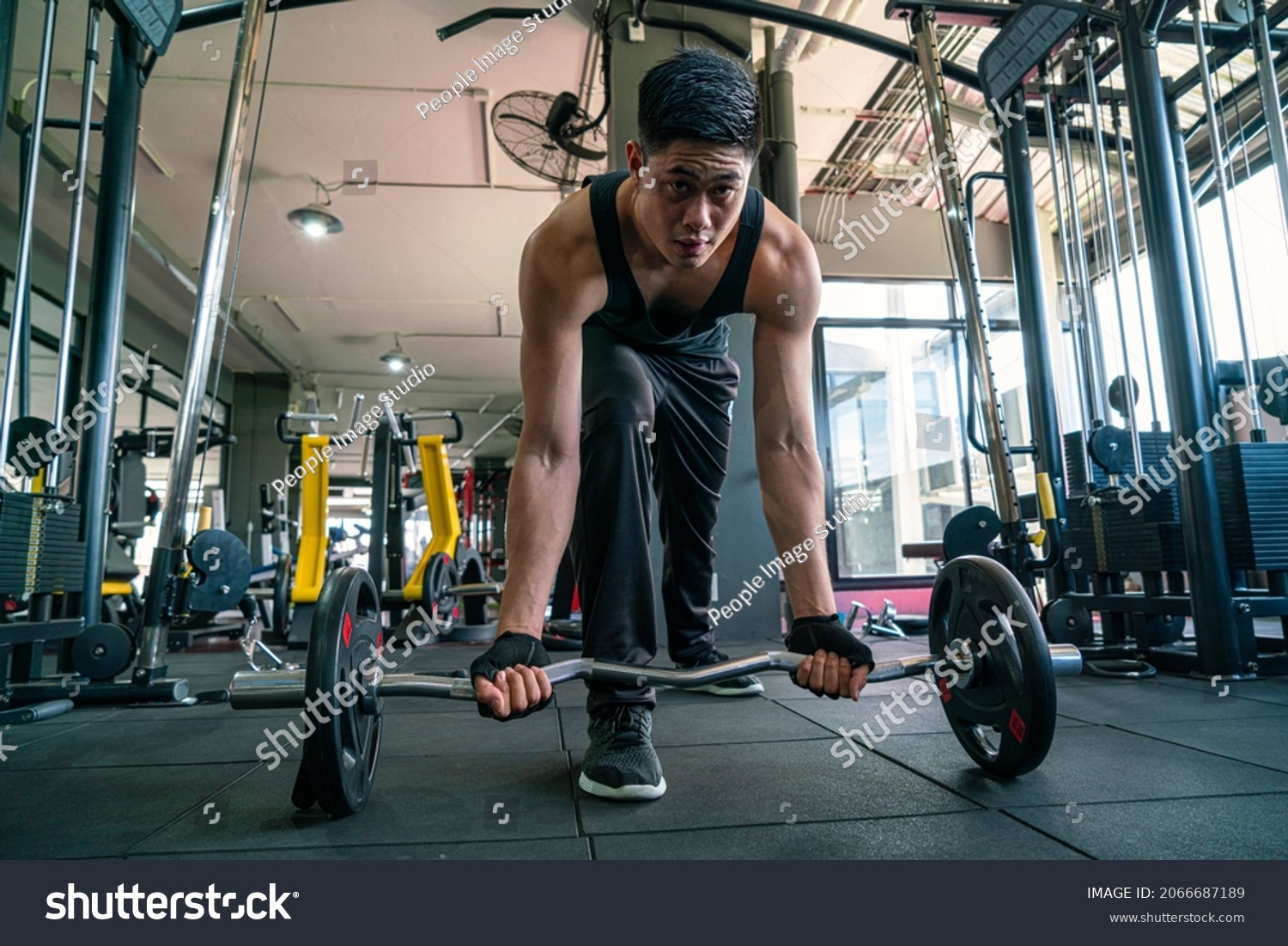 muscular man wearing sportswear using dumbbell bodyweight doing exercise for bodybuilding workout in fitness gym. fitness training bodyweight building and workout exercise concept