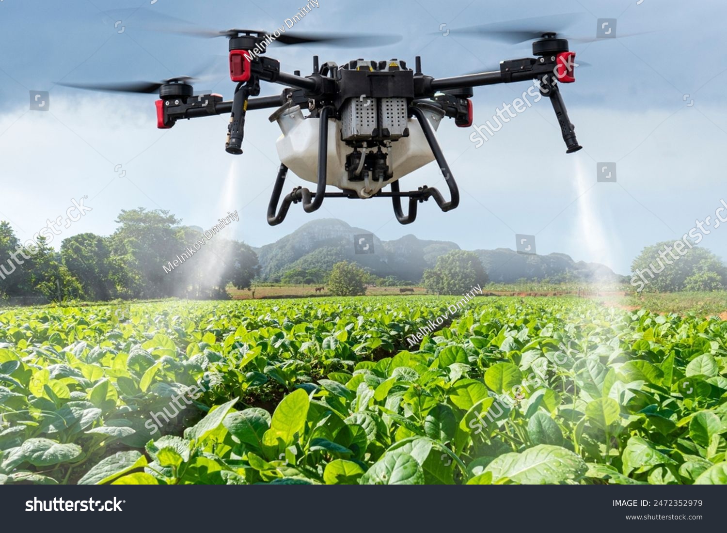 An industrial drone on green field. sprays useful pesticides to increase productivity and destroy harmful insects. increase productivity. Modern technologies in agriculture