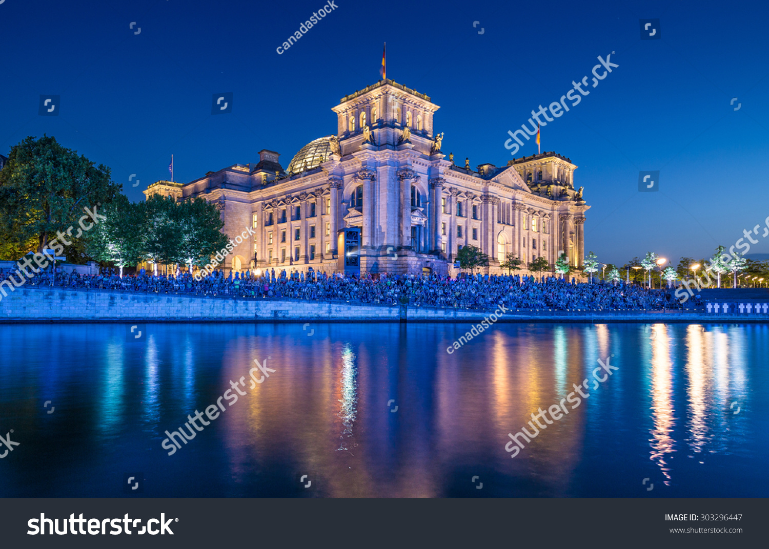 Panoramic view of famous Reichstag building seat of the German Parliament (Deutscher Bundestag) with Spree river in twilight during blue hour at dusk Berlin Mitte Germany