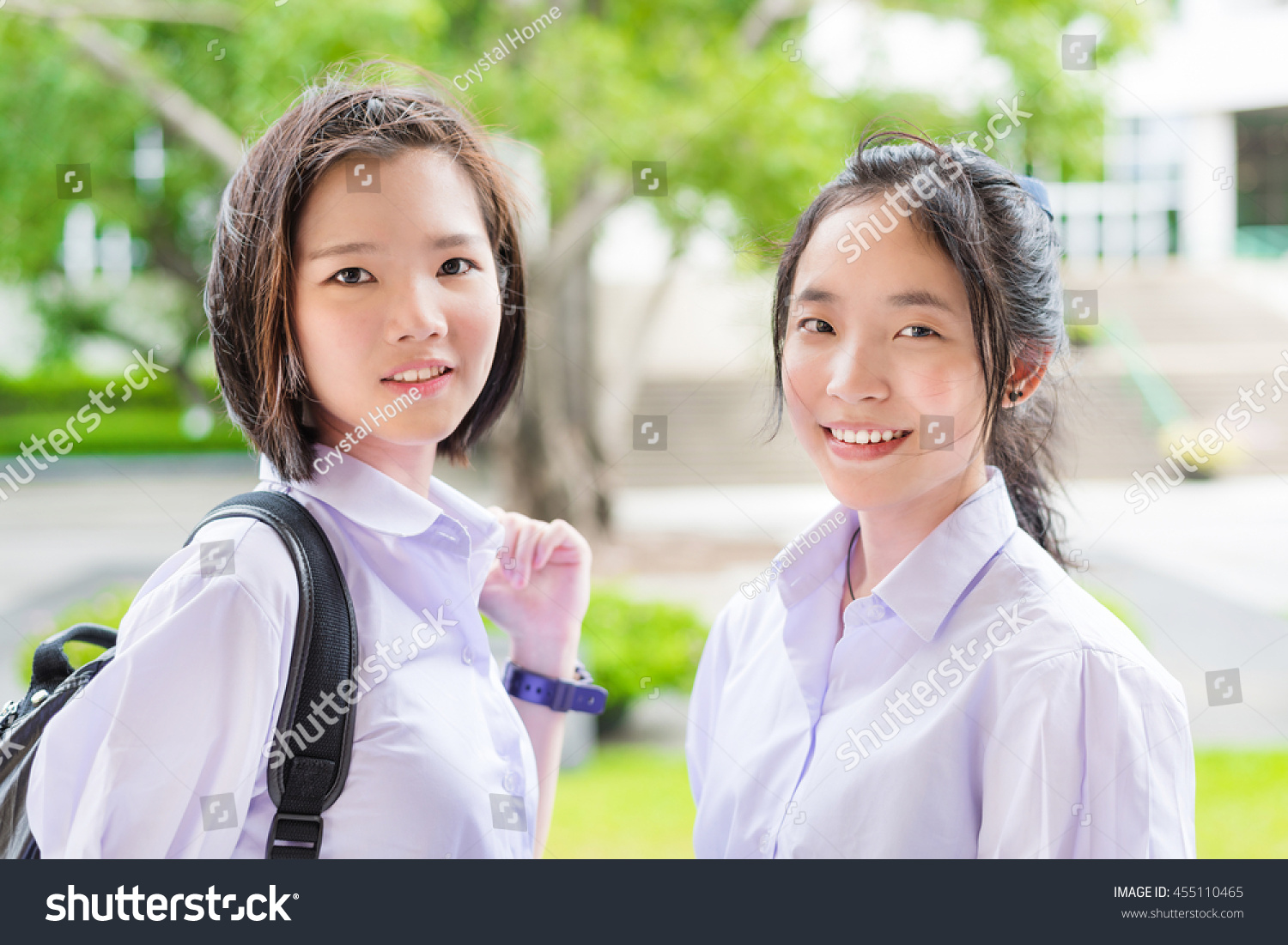 Cute Asian Thai high schoolgirls student couple in school uniform standing with her friend in a happy smile face expression
