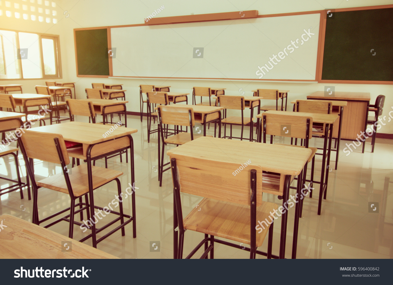 School classroom with desks chair wood sand blackboard in high school thailand vintage tone education concept
