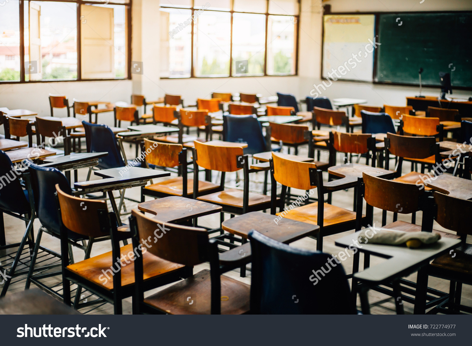 selective soft and blur focus.old wooden row lecture chairs in classroom in poor school.study room without student.concept for education
