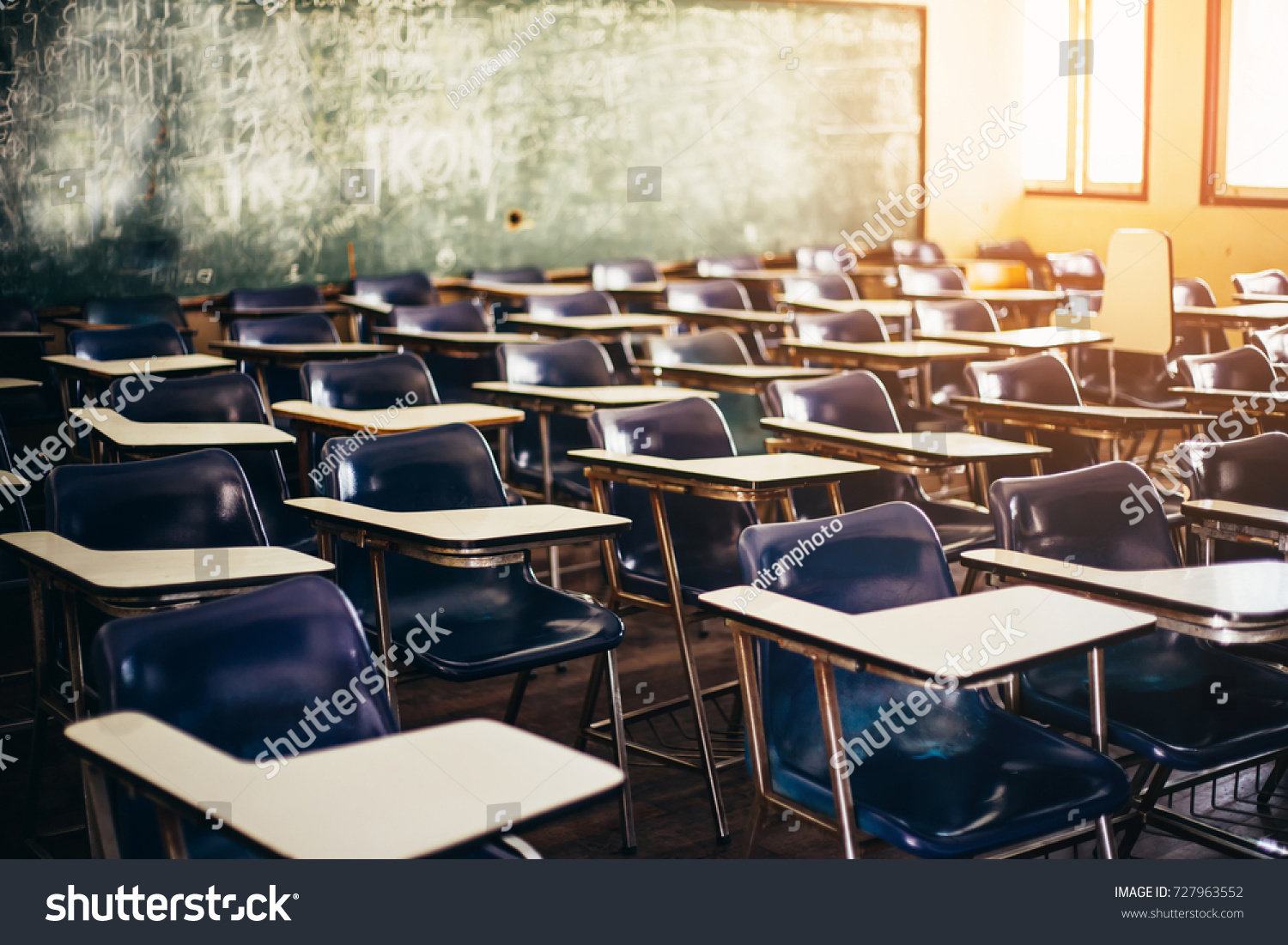 selective soft and blur focus.old wooden row lecture chairs in classroom in poor school.study room without student.