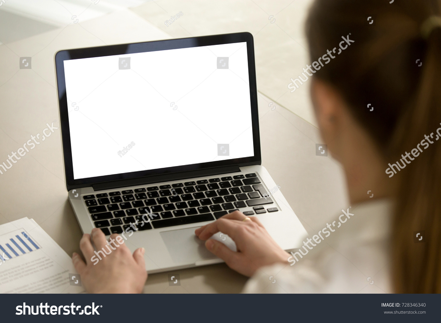 Businesswoman in office working on laptop with mockup blank screen. Empty copy space on monitor for business advertisement corporate website company financial report. Close up view focus on screen.