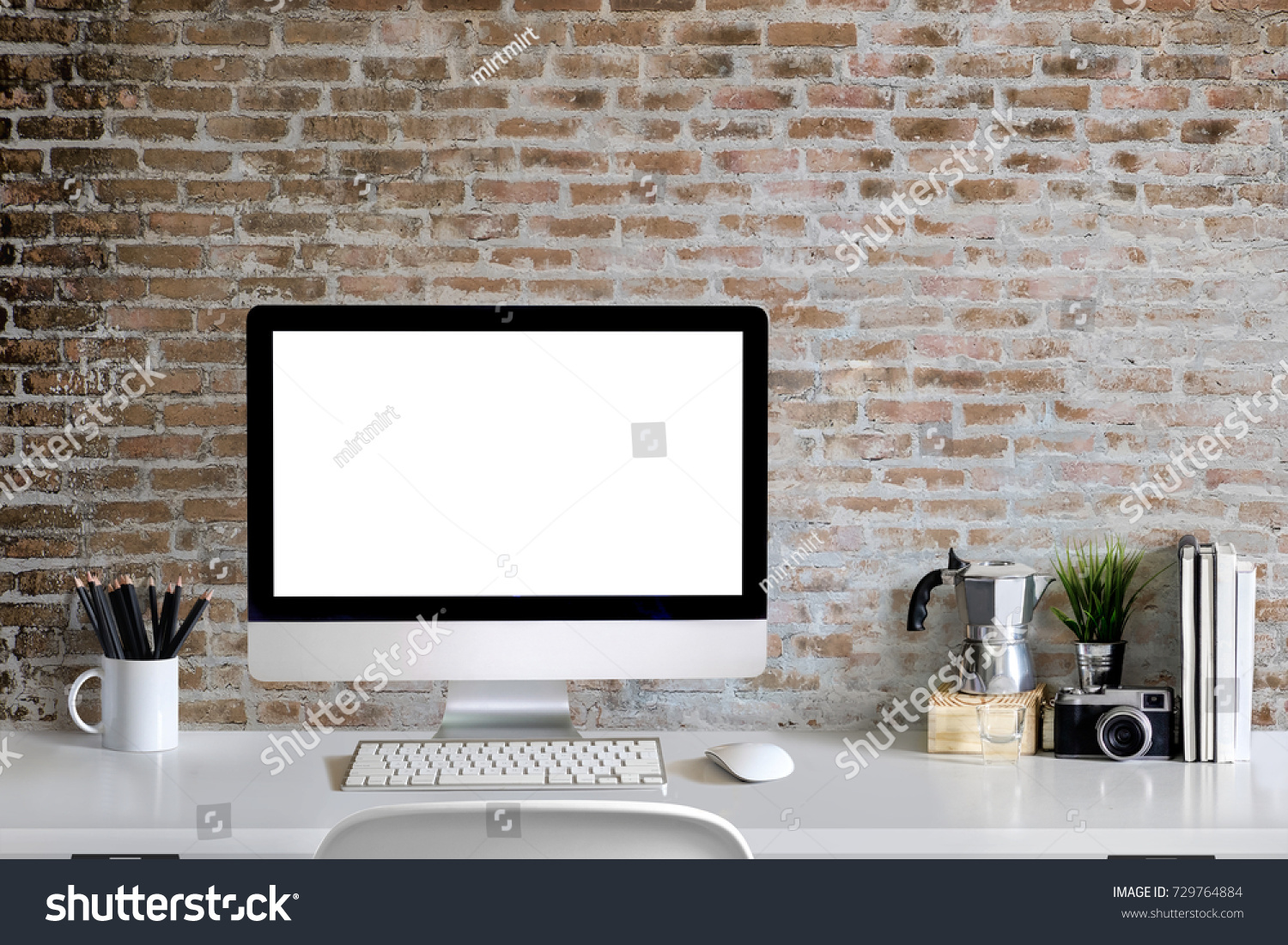 Loft workspace concept. Mock up white screen modern desktop computer and books minimal stuff on desk.