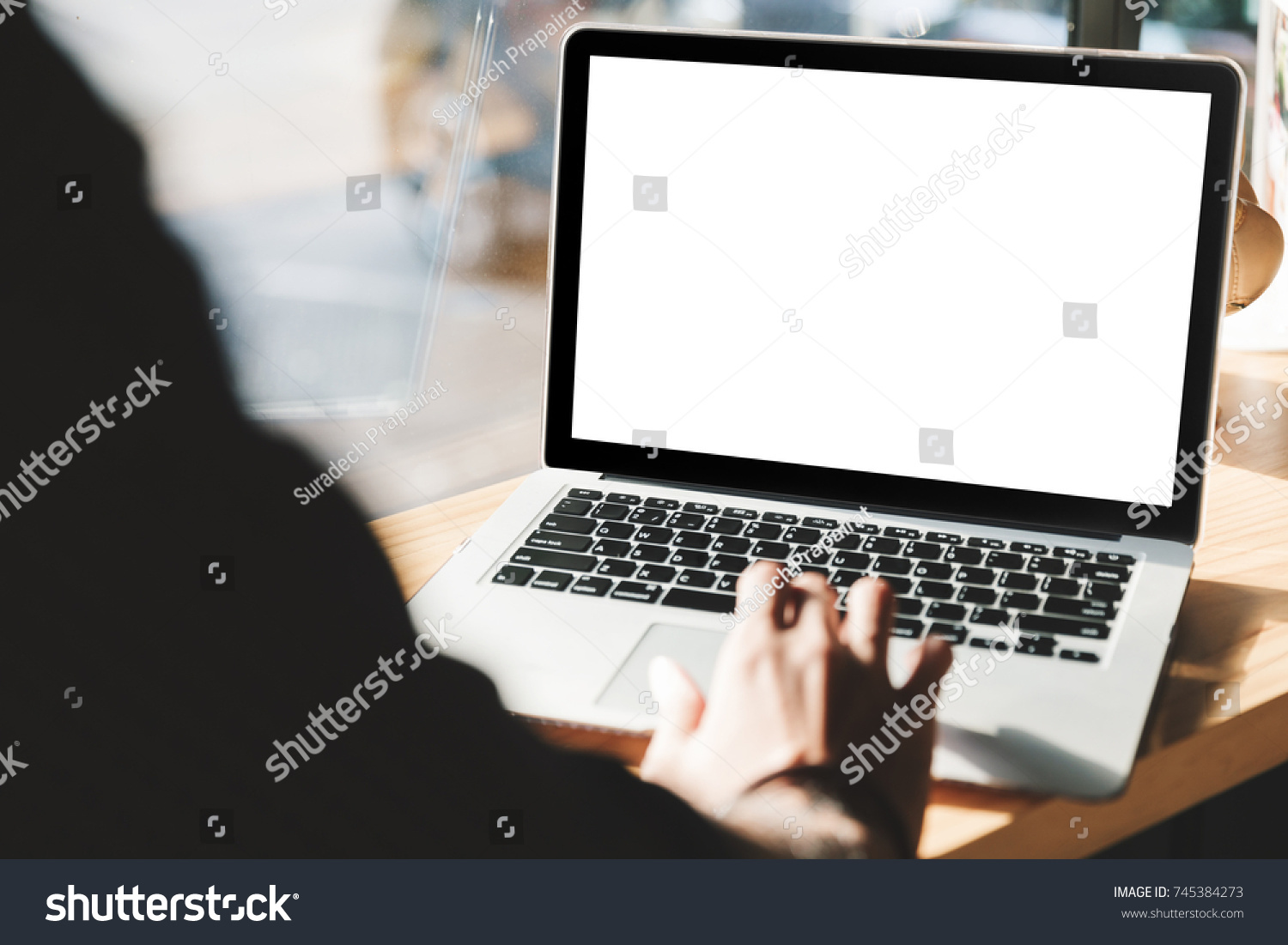 Young man working on his laptop with blank copy space screen for your advertising text message in office Back view of business man hands busy using laptop at office desk