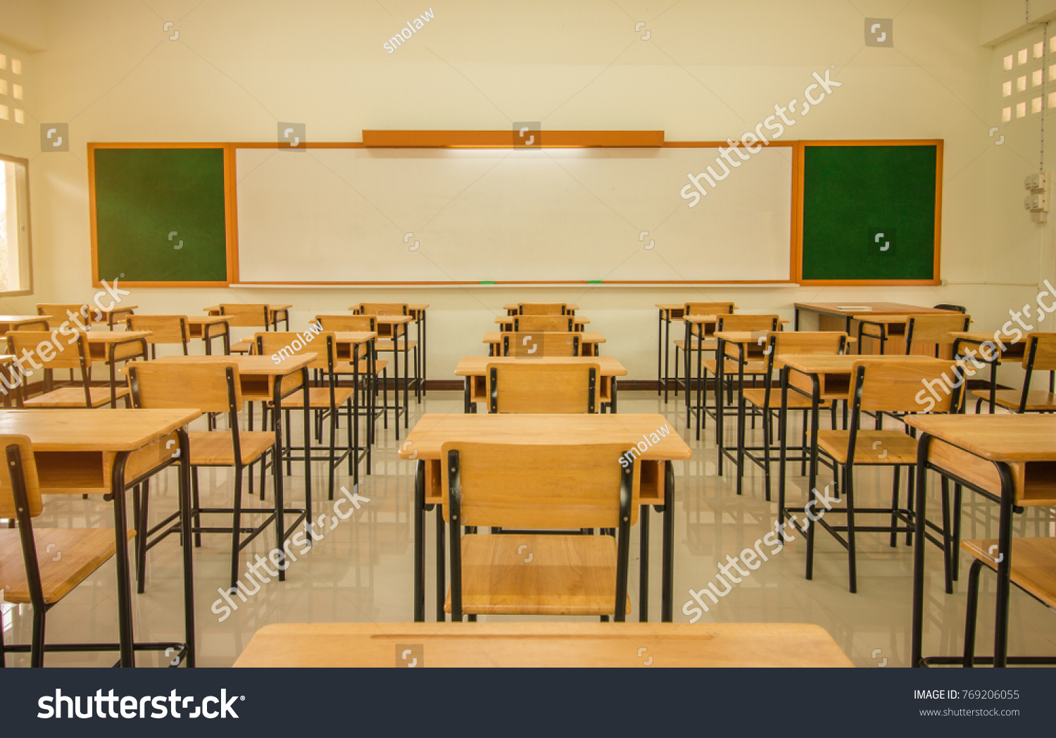 Lecture room or School empty classroom with desks and chair iron wood for studying lessons in high school Thailand interior of secondary education with whiteboard vintage tone educational concept