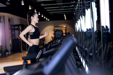 一名年轻女性在跑步机上面运动