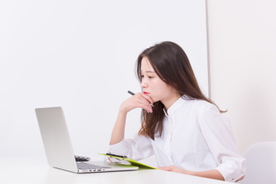 遇到问题的女性白领，对着电脑屏幕发呆