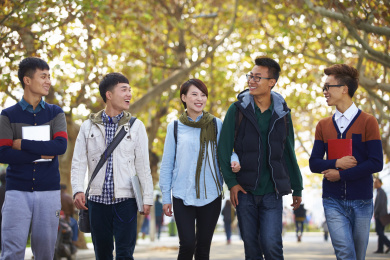 快乐的亚洲大学生在校园里走在一起