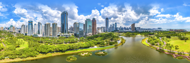 Panorama View. Haikou Cityscape and Skyline in front of the Evergreen Park in a Sunny Day.