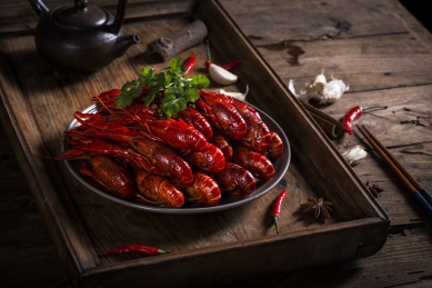 Crayfish. Red boiled crawfishes on table in rustic style closeup. Lobster closeup. Border design. Top view. Flat lay.
