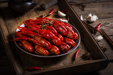 Crayfish. Red boiled crawfishes on table in rustic style closeup. Lobster closeup. Border design. Top view. Flat lay.