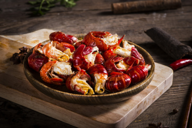 Crayfish. Red boiled crawfishes on table in rustic style closeup. Lobster closeup. Border design. Top view. Flat lay.