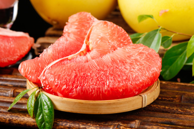 木底上筛子里装着的三块红柚果肉