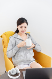 居家室内卧室使用笔记本电脑的女性