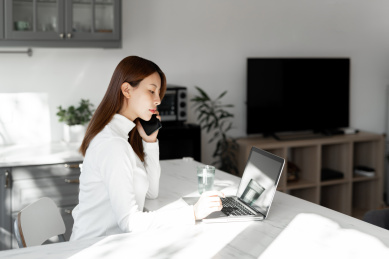 一位年轻女性在沙发上使用笔记本电脑