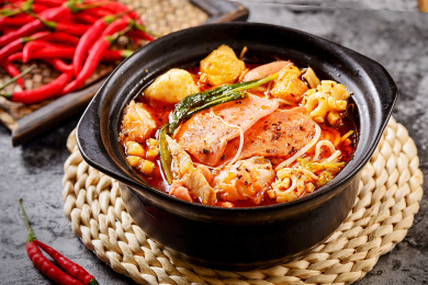 一碗砂锅麻辣烫放在岩石背景上