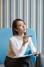手拿一支笔正在思考的职场女性