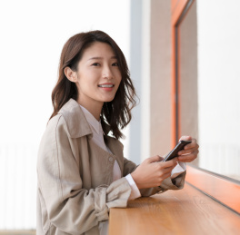 漂亮的亚洲女青年手拿手机