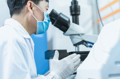 检验师正在使用显微镜检验样本