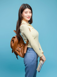 蓝色背景里，背着书包的亚洲美女