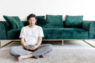 客厅里一名年轻男性拿着手机在思考