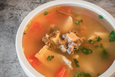 白色圆汤碗内的番茄山药牛尾汤