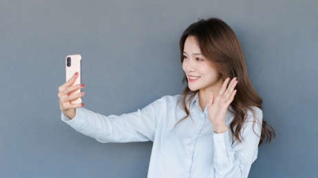 使用手机视频通话打招呼的女士