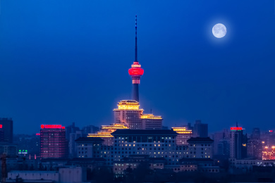 北京市夜晚月亮光照西城区中央电视塔建筑