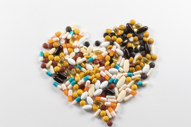 白色背景下一堆药物堆成了爱心