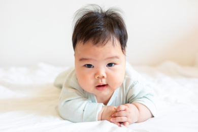 胖嘟嘟的婴儿趴在床上玩耍