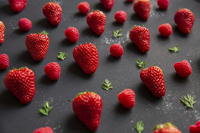 黑色背景中的红色草莓和树莓