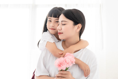 母亲节概念室内中国小女孩给妈妈送花